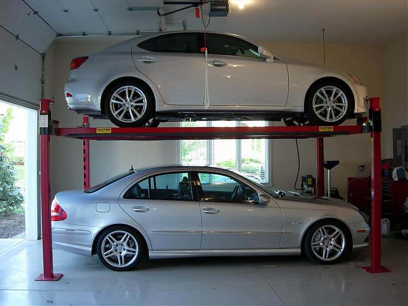 Two cars stacked on residential garage parking lift