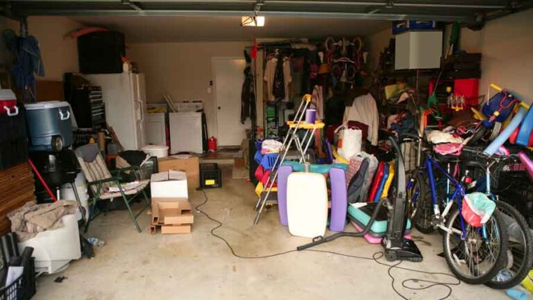 Cluttered garage with boxes, bikes, and toys