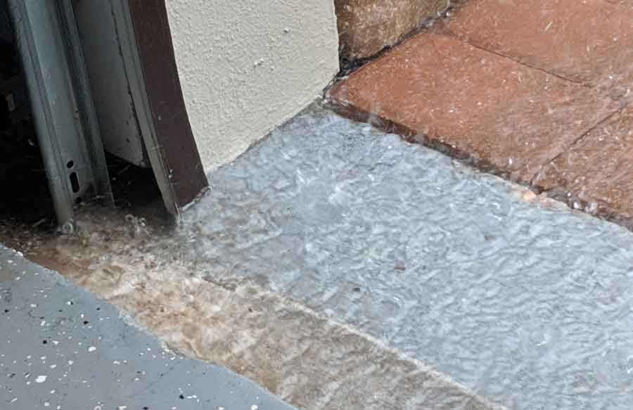 Water rushing in the front of my garage