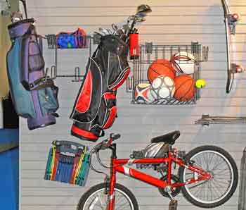 Sports equipment stored in garage on slatwall - Feature Image