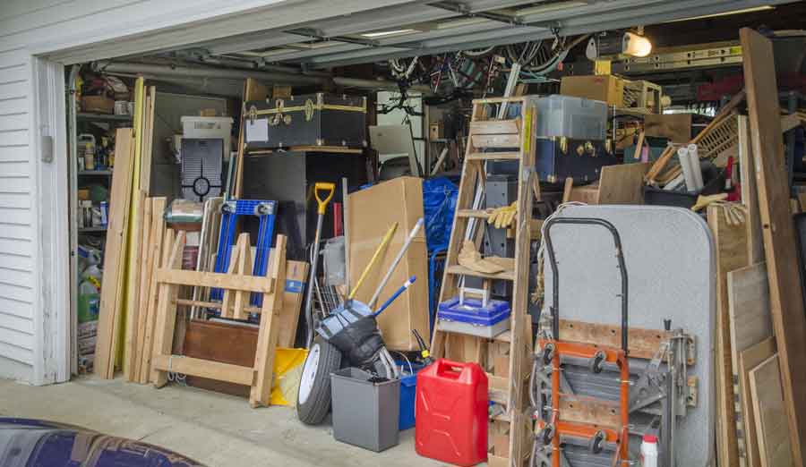 Boxes and junk stacked full in a garage