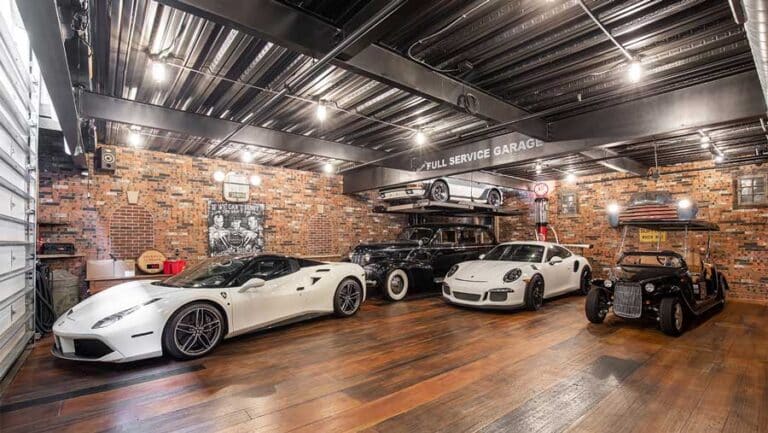 MotorEnclave car condo luxury garages: Modern rustic garage with Ferrari and Porsche
