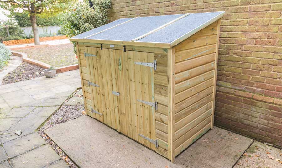 Lean-to shed attached to brick wall