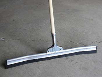 Curved garage floor squeegee on concrete
