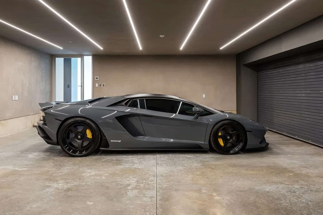 Lambo parked in garage with brown painted walls