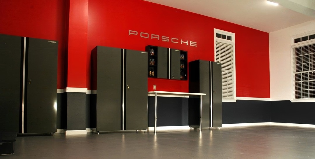 Garage with black and red striped walls and Porsche logo