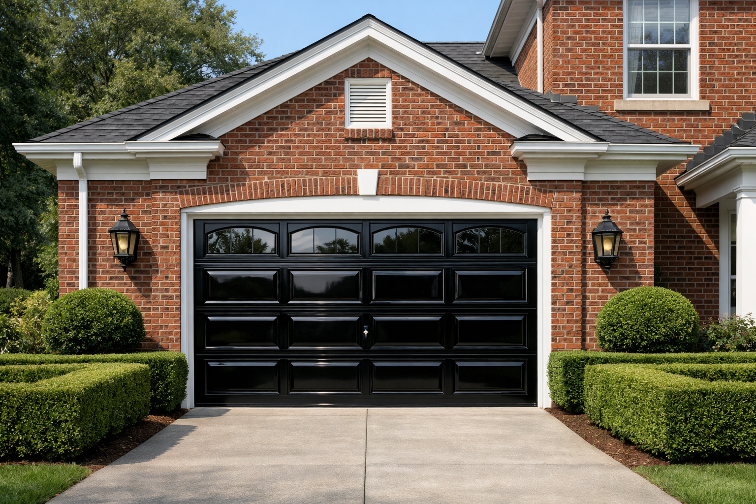 Traditional brick home featuring glossy black garage door with white trim