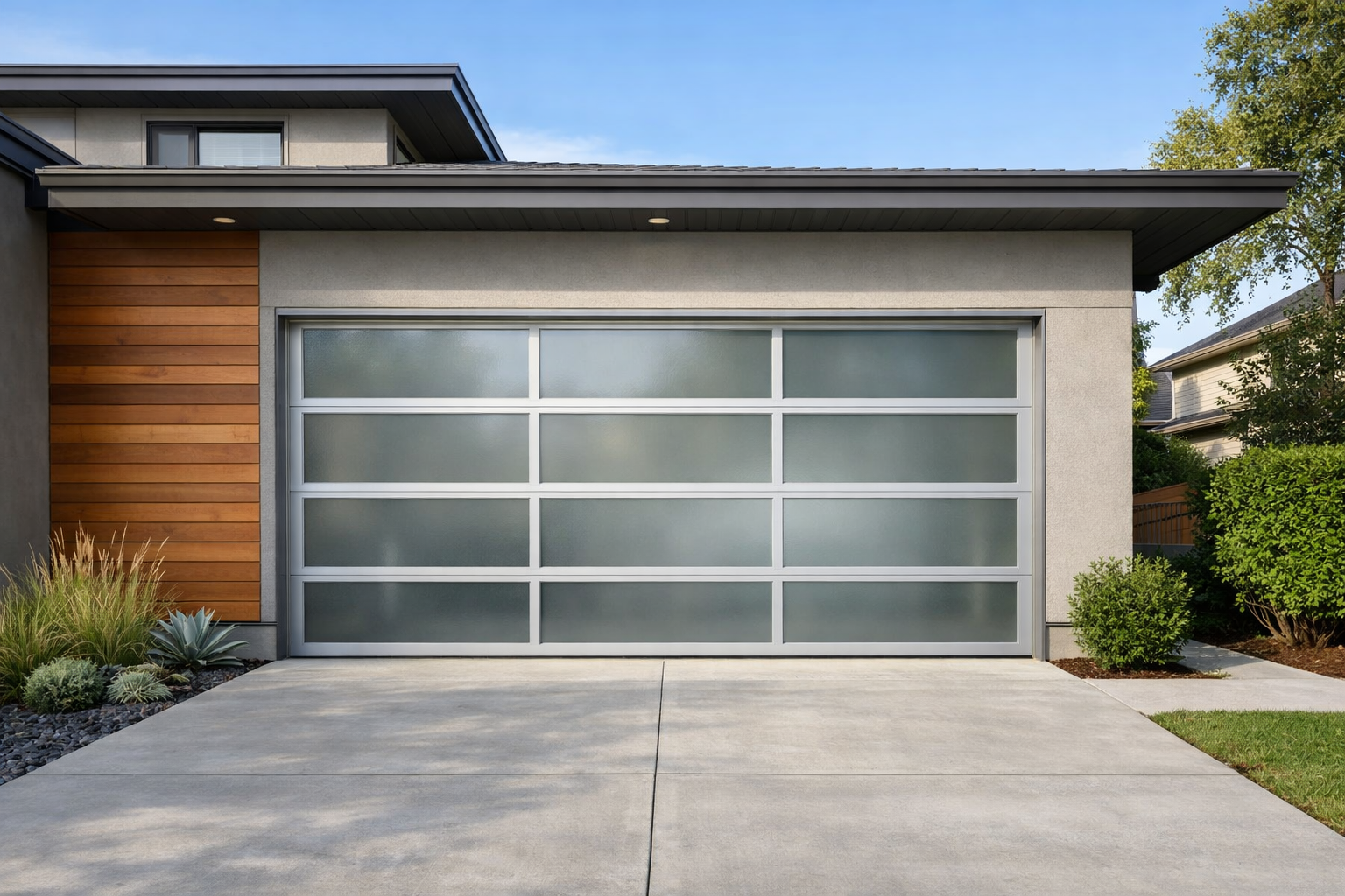 Contemporary home featuring frosted glass garage door with silver aluminum frames