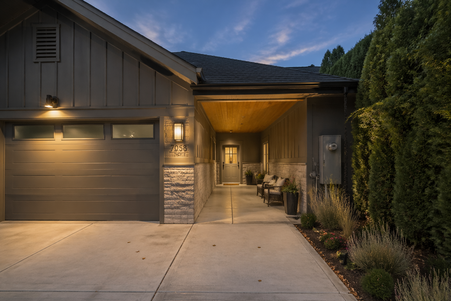 Private garage in-law suite entrance with covered walkway and landscaping