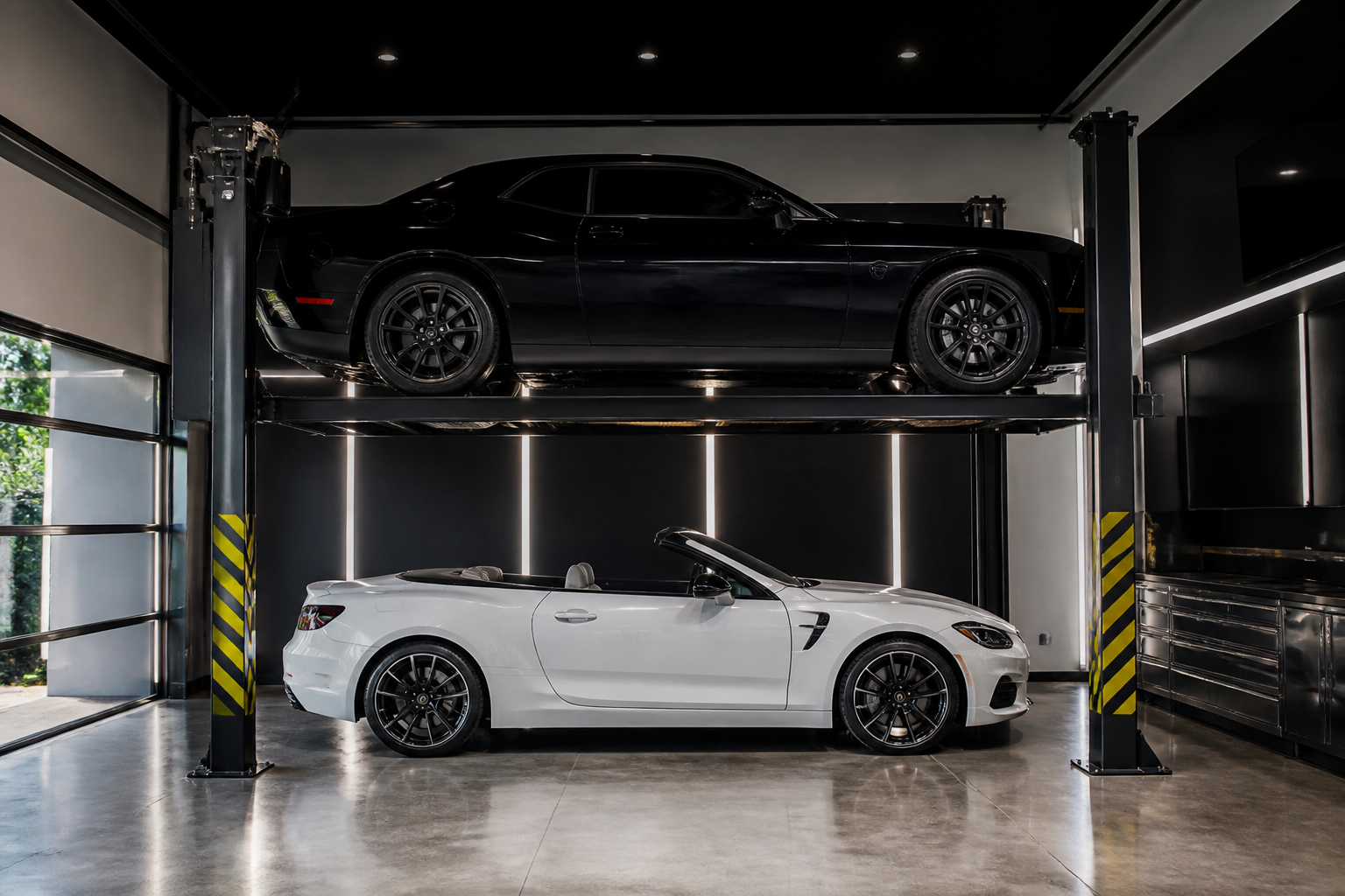 Two-post symmetric lift with black muscle car elevated above white convertible in home garage