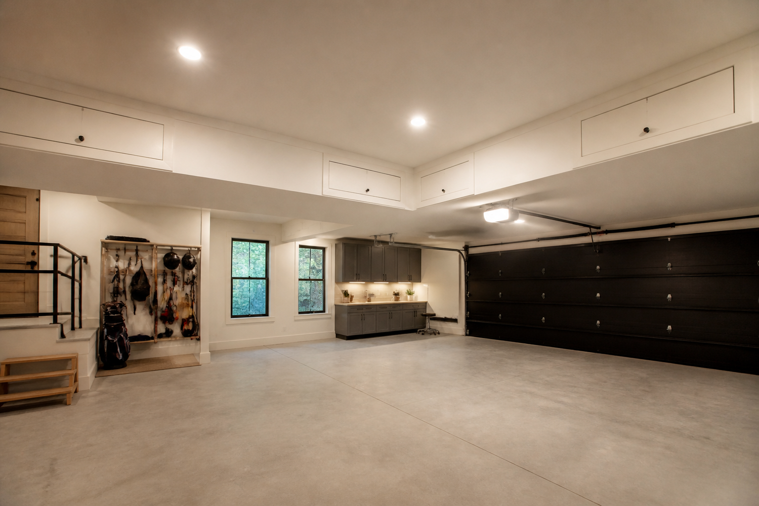 White soffit-style storage boxes built into garage ceiling perimeter with small access doors