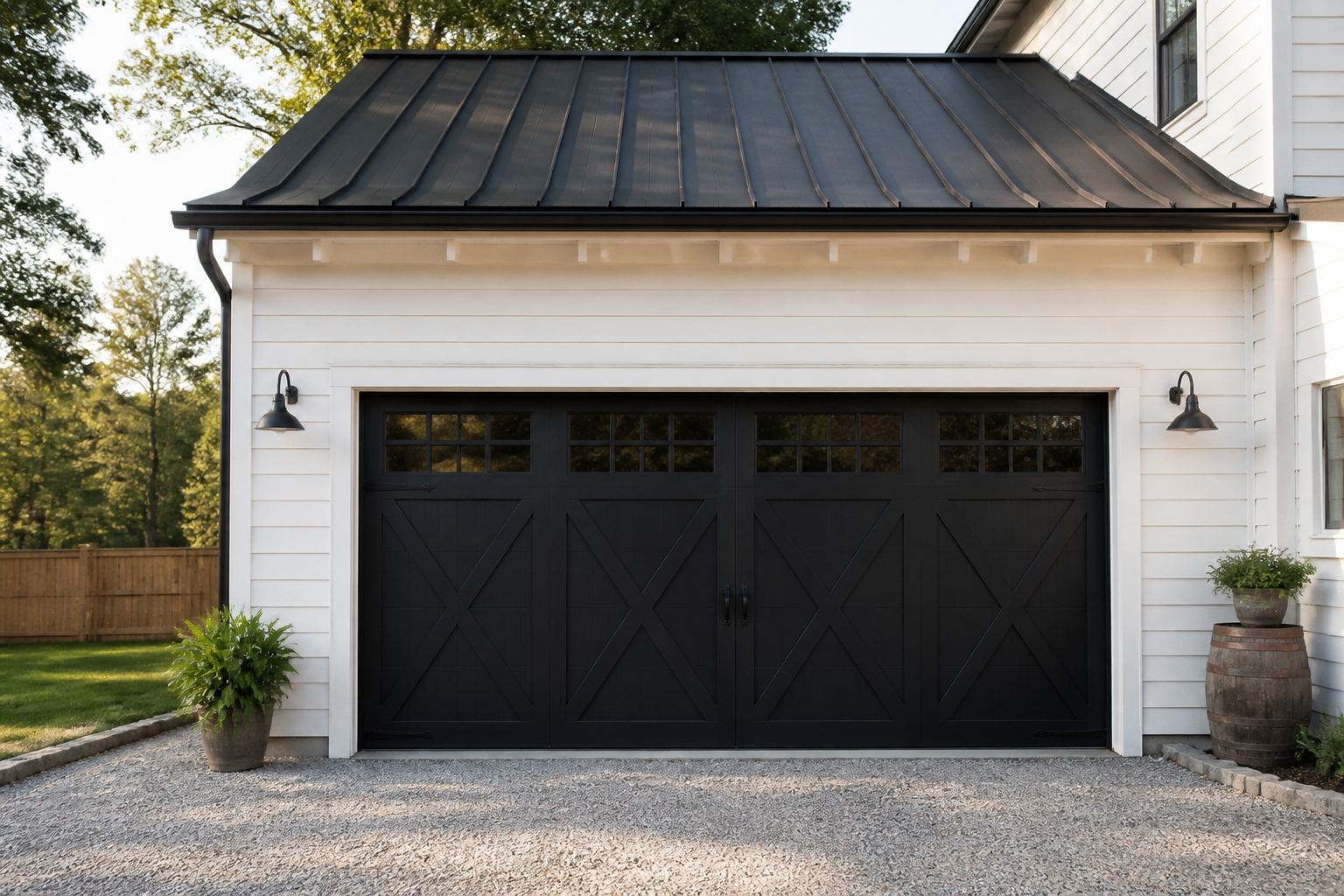 Black barn-style garage door with X-pattern overlay on white shiplap siding