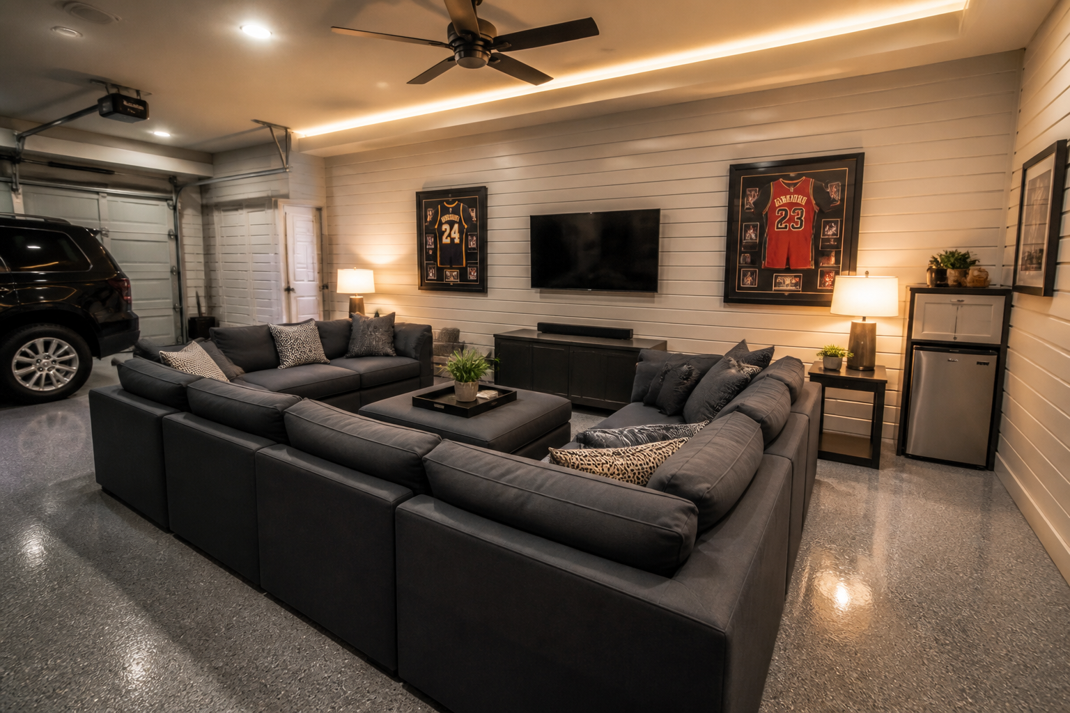Modular sectional seating arrangement in garage lounge with LED perimeter lighting and storage walls