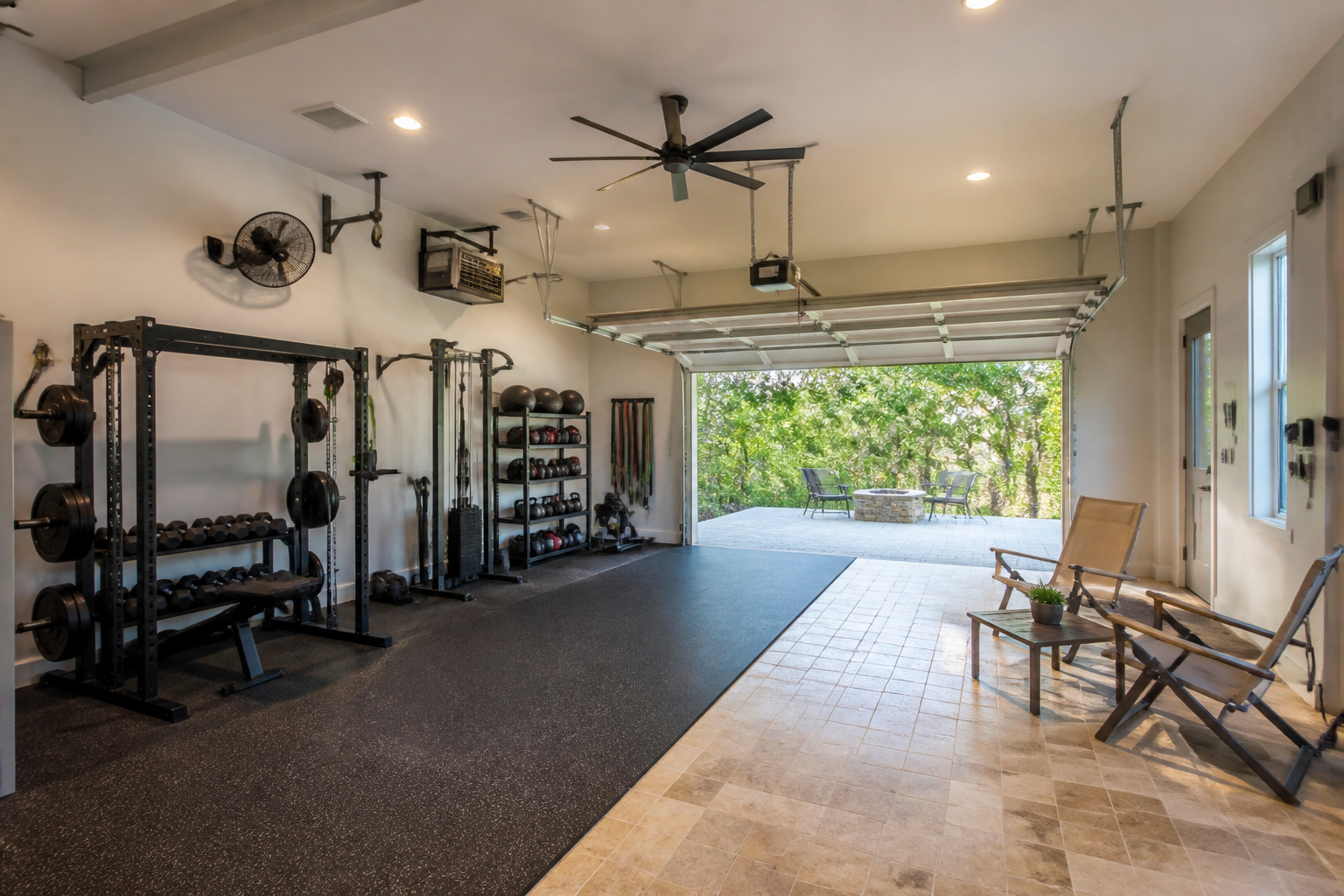 Garage gym and lounge hybrid with rubber flooring, exercise equipment, and folding furniture