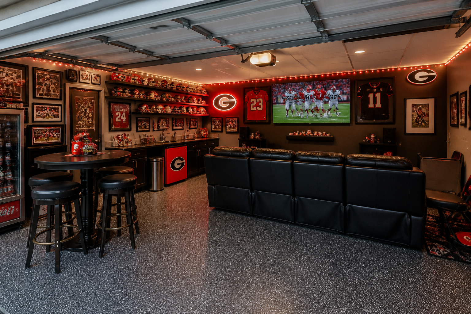 Sports bar garage lounge with black leather sofa, mounted TV, and team memorabilia