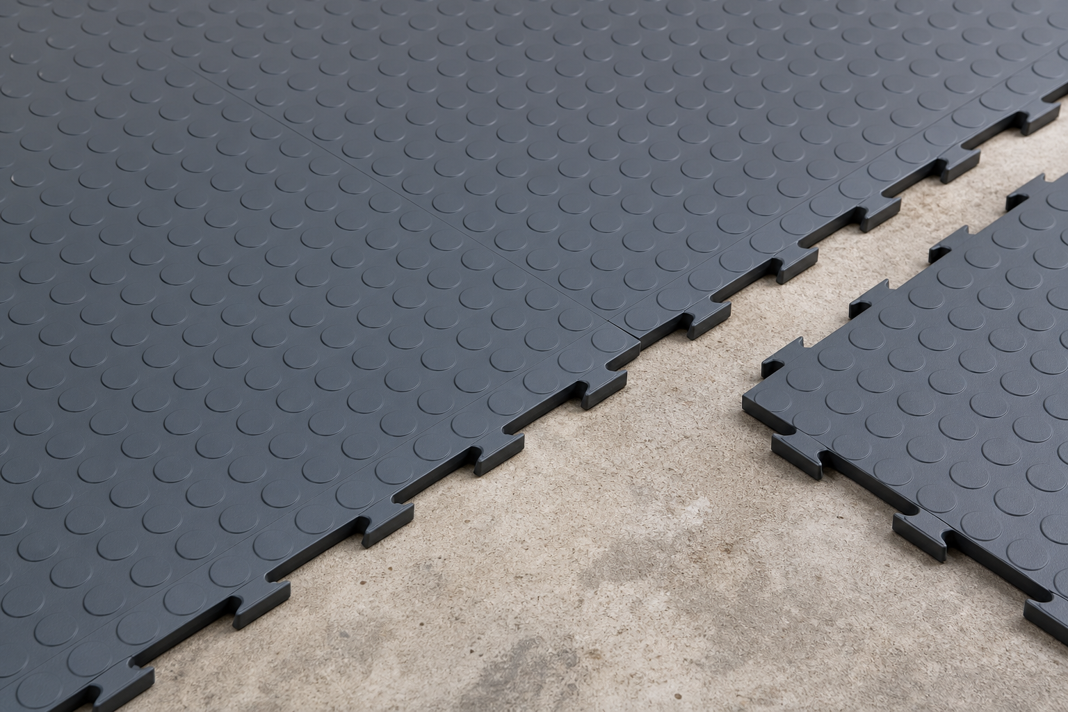 Interlocking garage floor tiles showing connection mechanism and textured surface