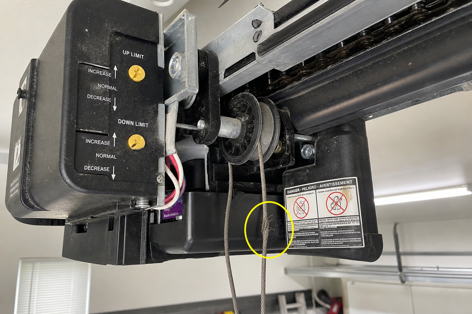 Garage door opener showing travel limit adjustments and worn mechanical components