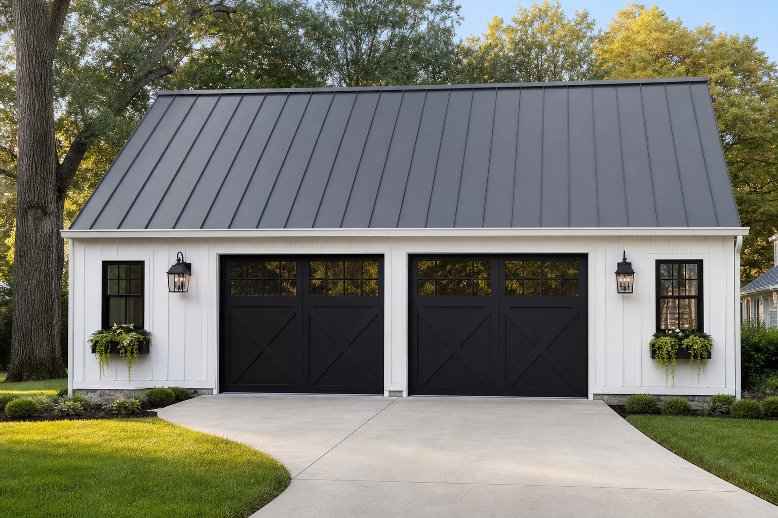 White board-and-batten detached garage with black carriage doors and metal roof