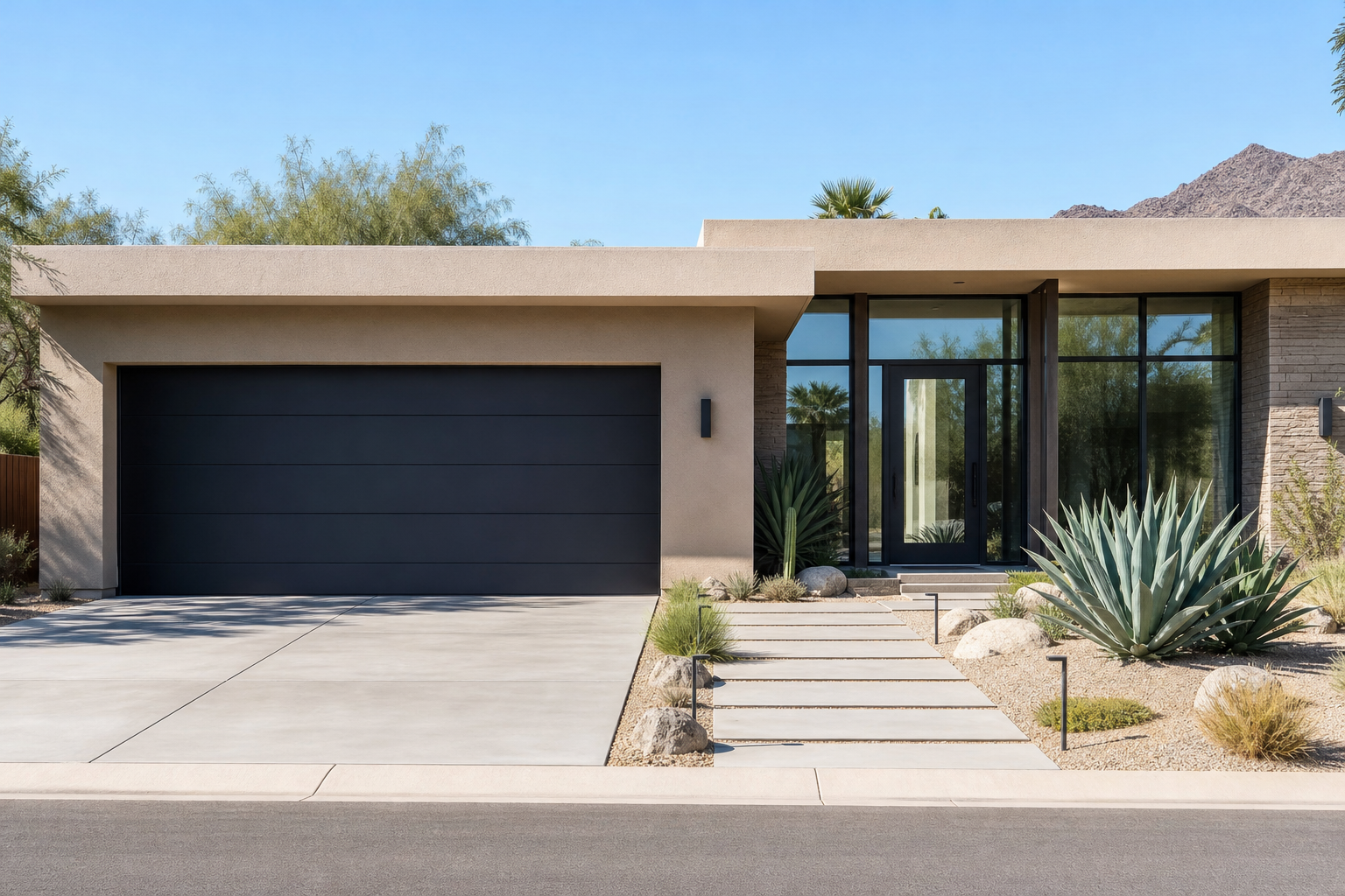 Matte black smooth-panel garage door on a tan stucco mid-century modern home