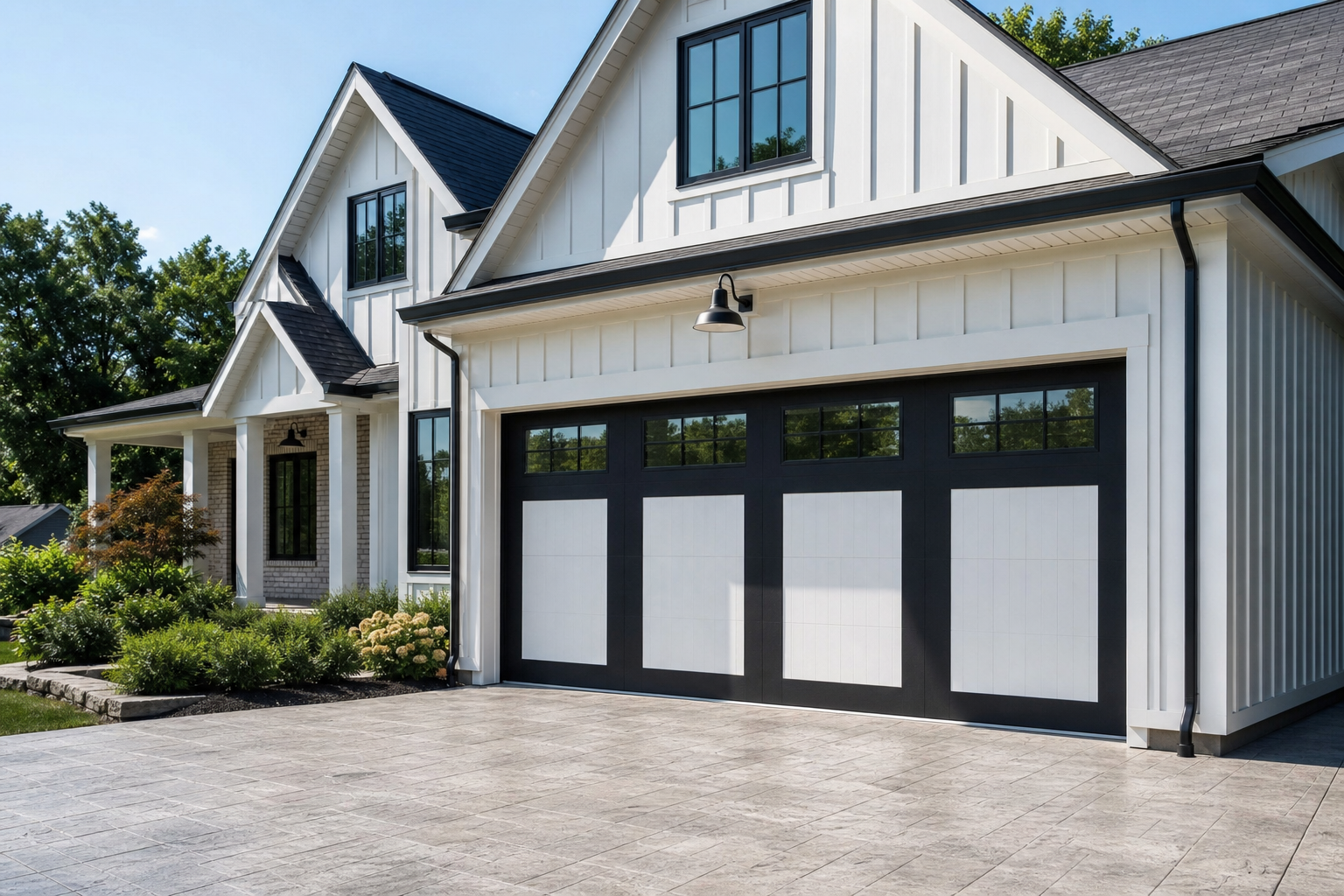 Two-tone garage door with white panels and black frame on a modern farmhouse