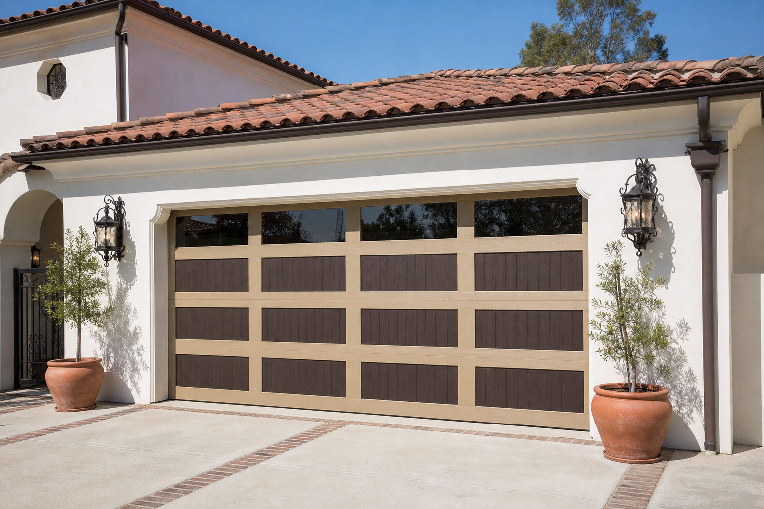 Sand and espresso two-tone raised-panel garage door on a Mediterranean stucco home