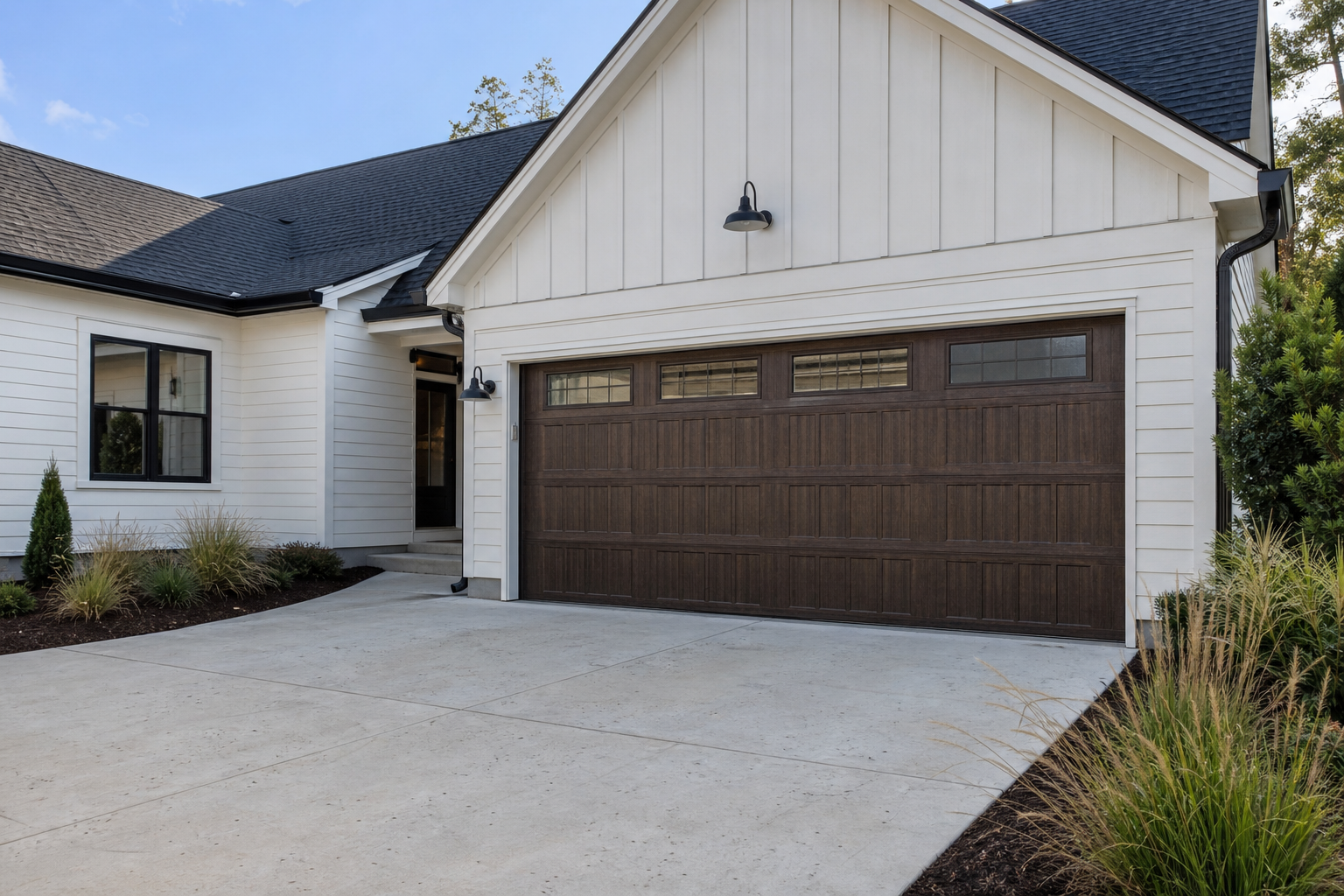 Dark walnut faux-wood steel garage door on a white modern farmhouse exterior