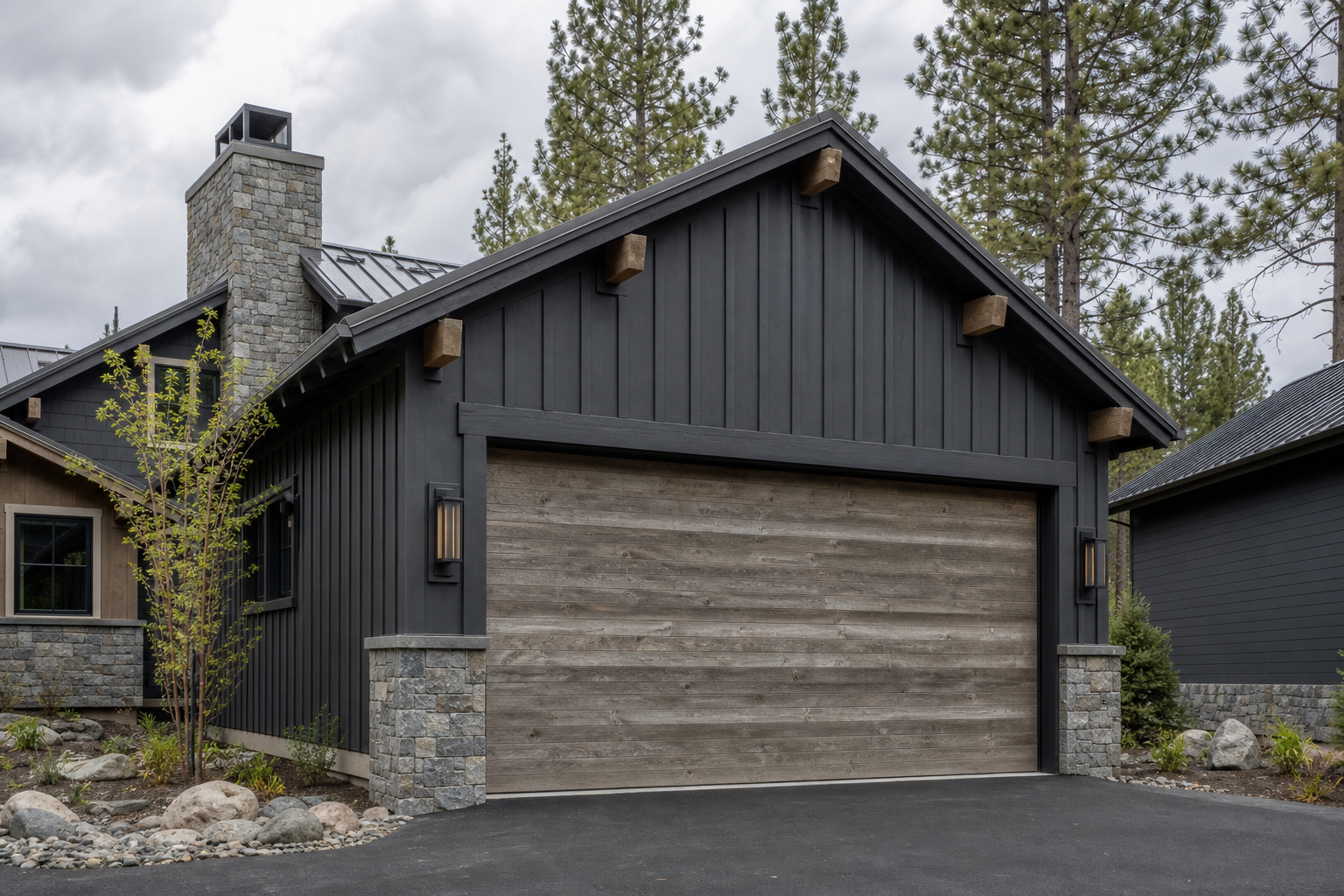 Weathered driftwood gray wood-look garage door on a dark mountain cabin home