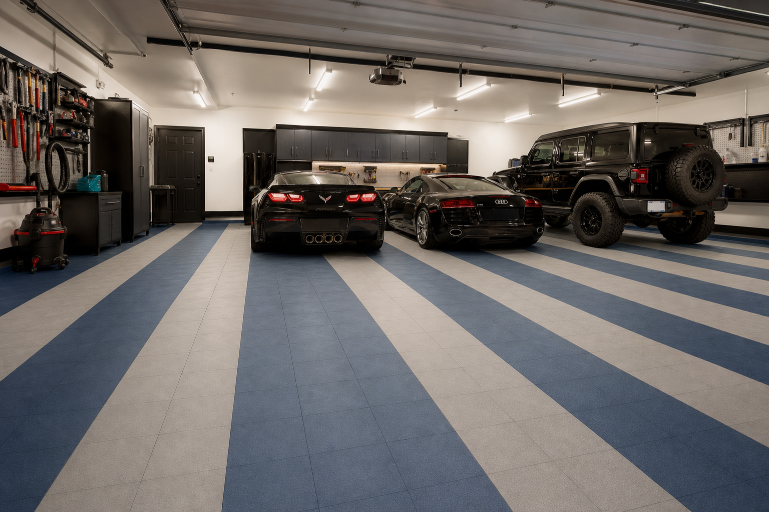 Two-tone slate blue and gray interlocking polypropylene garage floor tile pattern in three-car garage