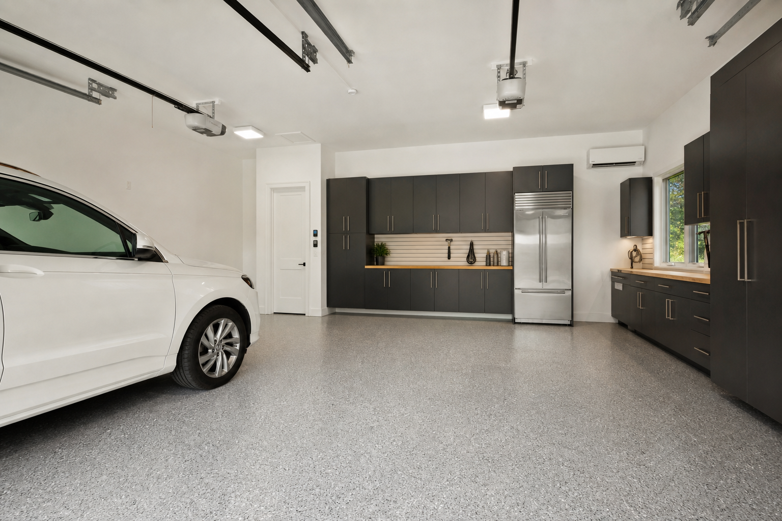 White walls and gray epoxy floor in a clean modern two-car garage interior