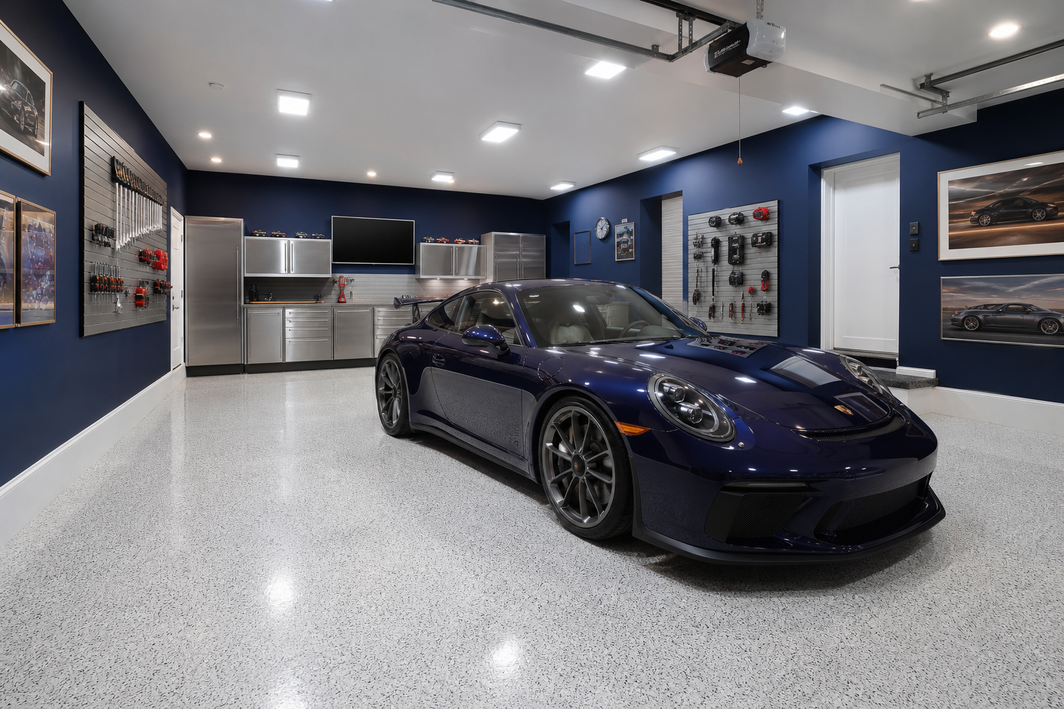 Navy blue garage walls with white epoxy floor and stainless steel cabinet accents