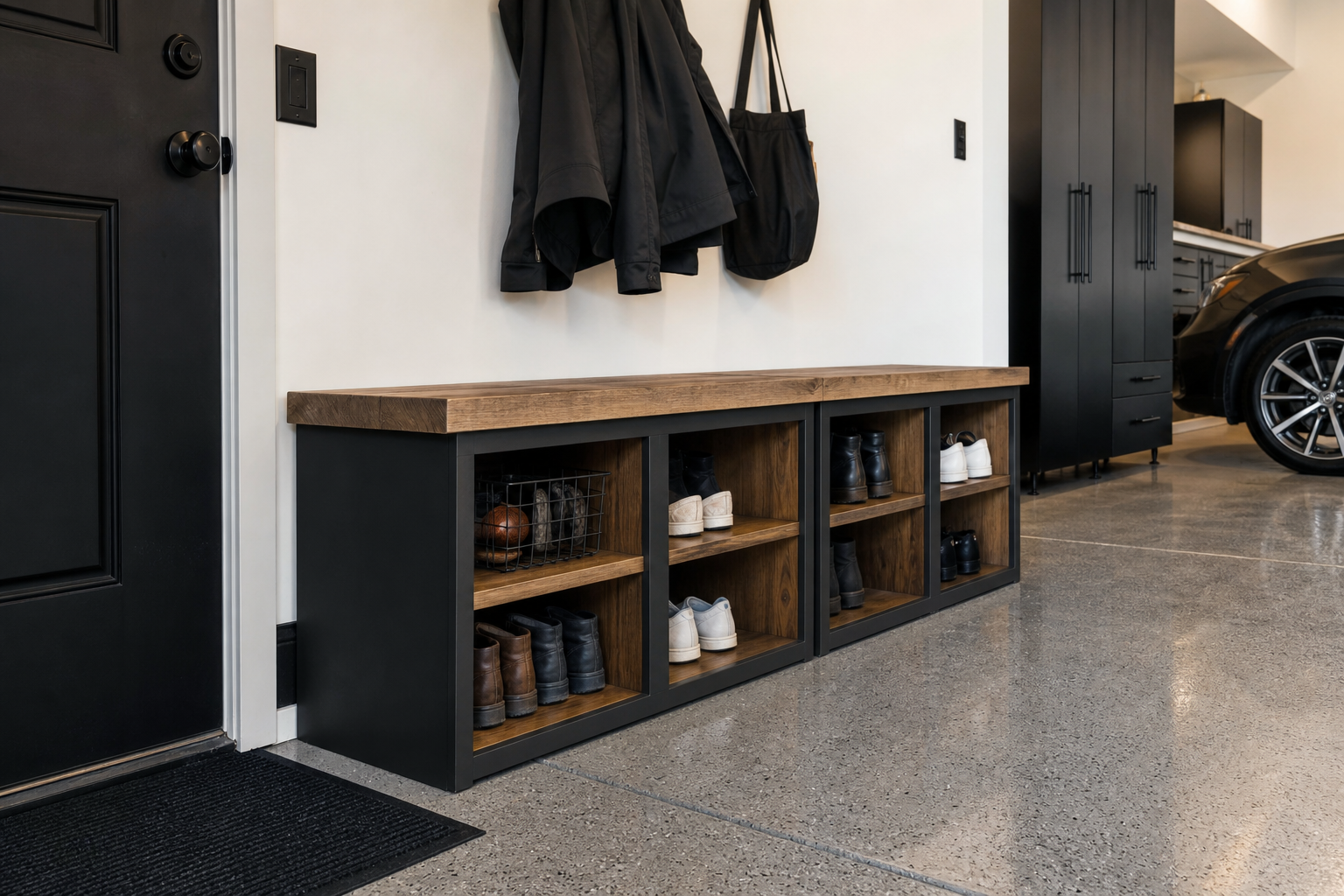 Charcoal gray cubby bench with natural wood inserts and wire baskets in a modern garage