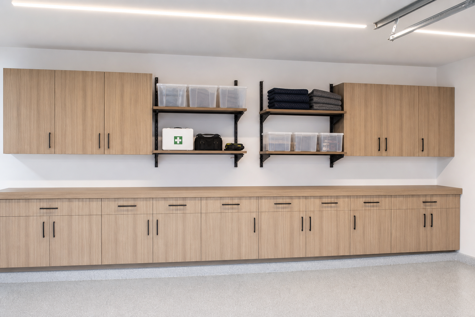 Light wood grain garage cabinets with black bracket open shelves built into the upper cabinet run
