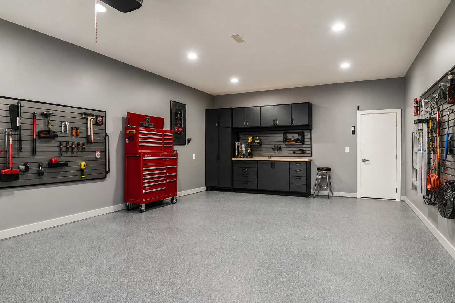 Satin finish mid-tone gray drywall garage walls under LED lighting with tool storage