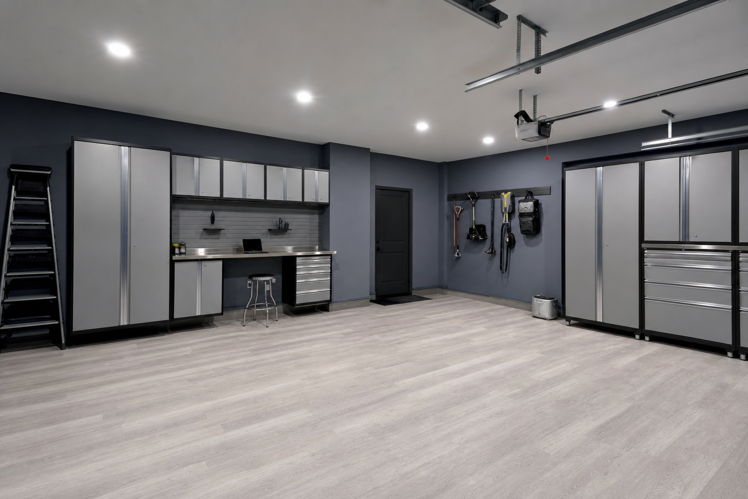 Slate blue-gray garage walls with concrete-look vinyl plank floor and stainless steel cabinet accents
