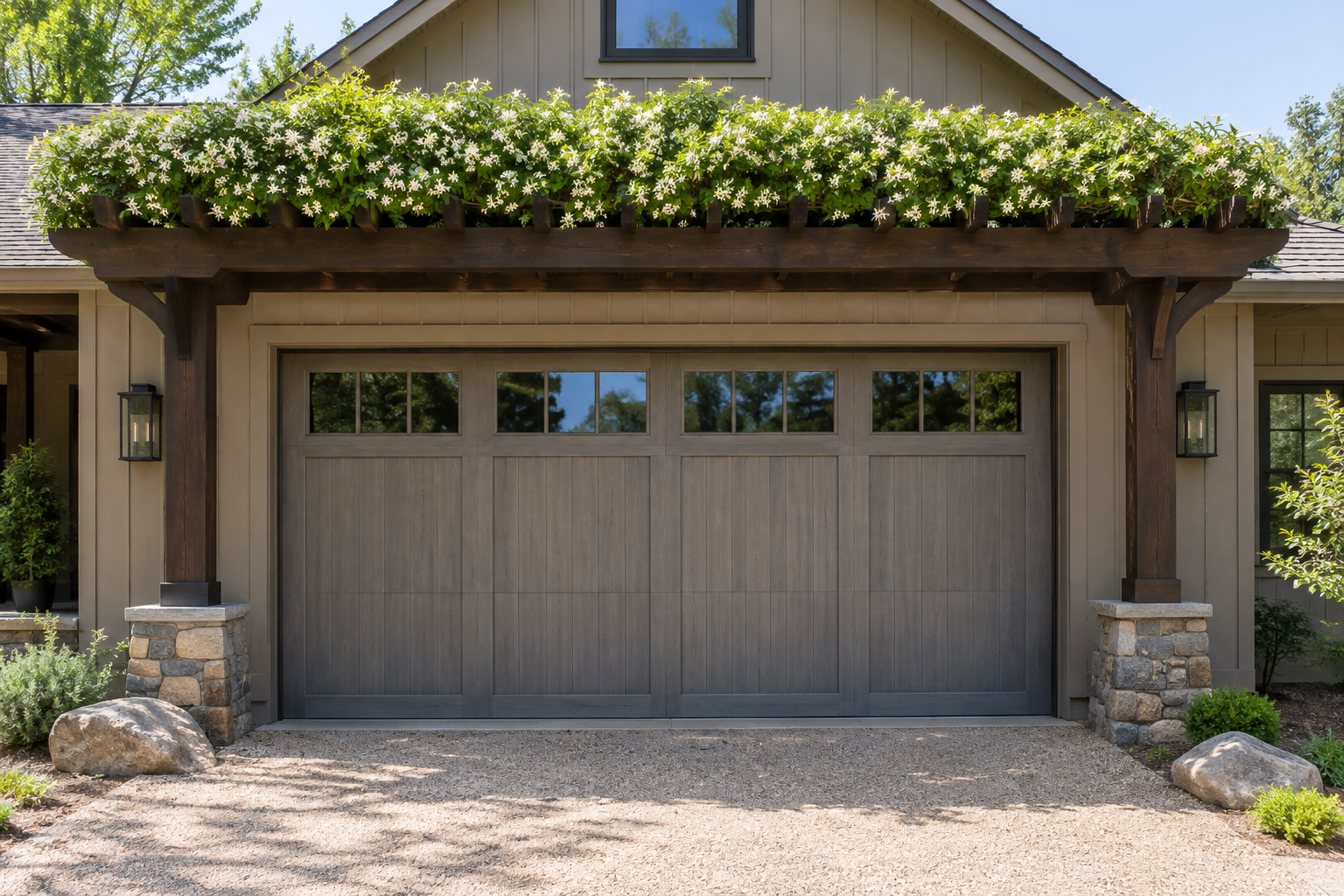 Dark cedar pergola with dense green star jasmine covering the top beams over a gray craftsman garage door